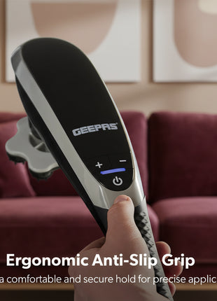 Hand holding a GEEPAS handheld device with ergonomic anti-slip grip on a blurred outdoor background