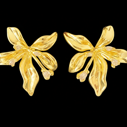 Pair of gold floral earrings on a black background