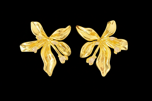 Pair of gold floral earrings on a black background