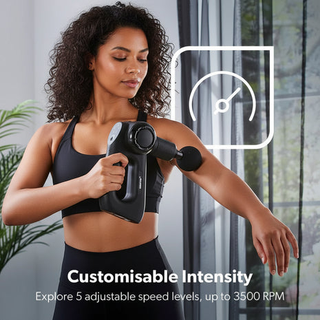 Woman using a handheld massage device on her arm with text about customizable intensity.