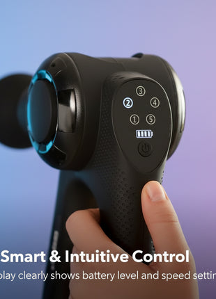 Handheld massage device with control panel and LED display, held by a person.
