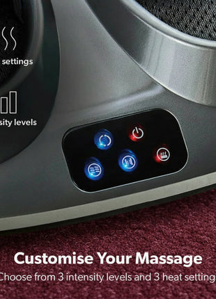 Massage device with control panel and text indicating heat settings and intensity levels on a carpeted floor.
