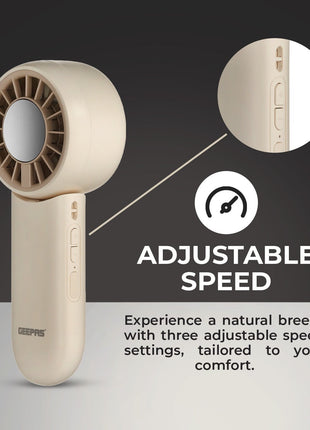 Beige handheld fan with adjustable speed feature on a dark background