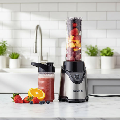 Geepas portable blender with a container of juice and fruits on a white background