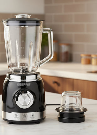 Black blender with clear jar and attachment on a white background