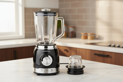 Black blender with clear jar and attachment on a white background