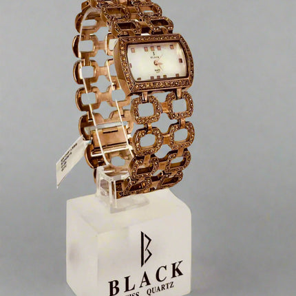 Decorative watch with intricate design on a gray background