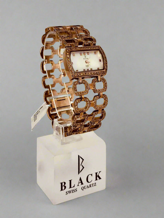 Decorative watch with intricate design on a gray background