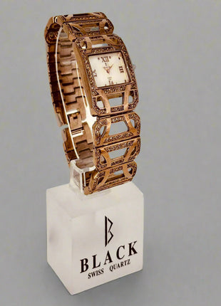 Decorative watch with intricate design on a gray background