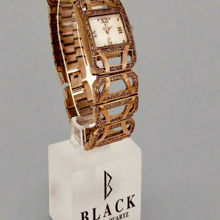 Decorative watch with intricate design on a gray background