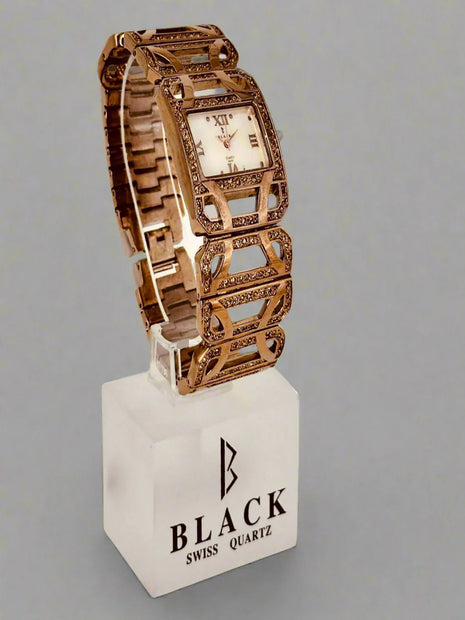 Decorative watch with intricate design on a gray background