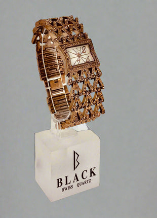 Decorative watch on a stand with 'Black Swiss Quartz' branding against a gray background