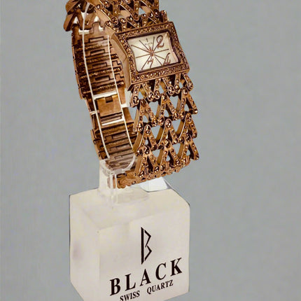 Decorative watch on a stand with 'Black Swiss Quartz' branding against a gray background