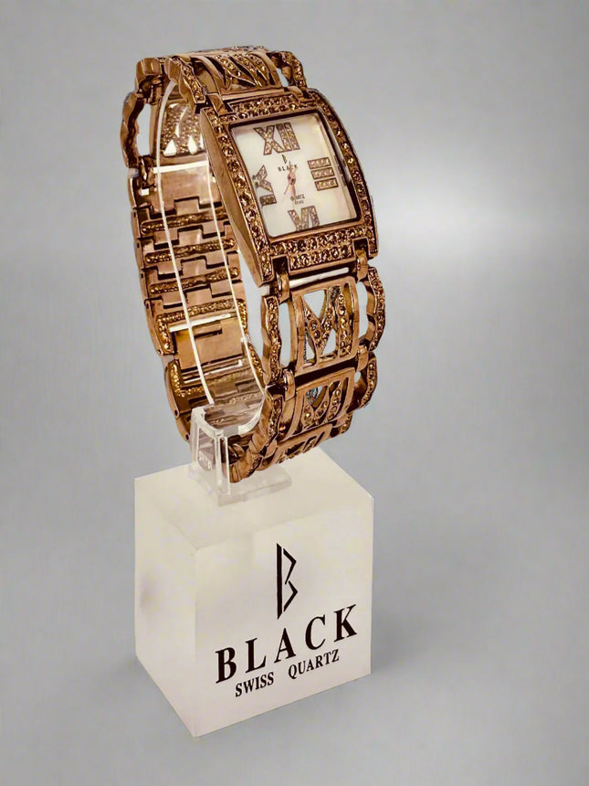 Gold wristwatch on a white stand with 'Black Swiss Quartz' branding against a gray background