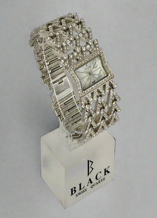Silver bracelet watch on a stand with 'Black Swiss Quartz' branding