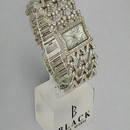 Silver bracelet watch on a stand with 'Black Swiss Quartz' branding