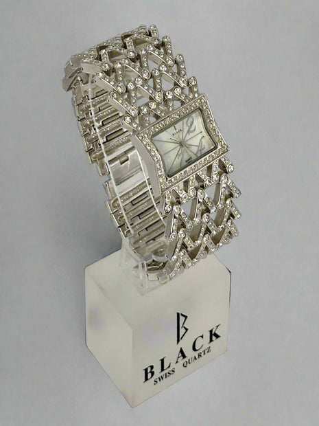 Silver bracelet watch on a stand with 'Black Swiss Quartz' branding