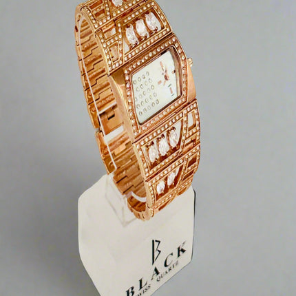 Rose gold watch on a display stand with a gray background