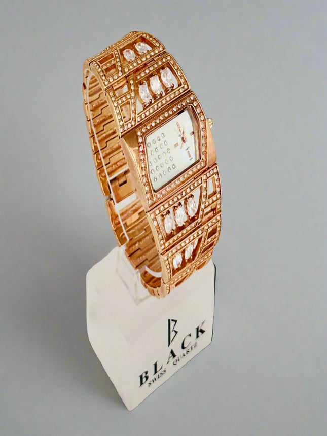 Rose gold watch on a display stand with a gray background