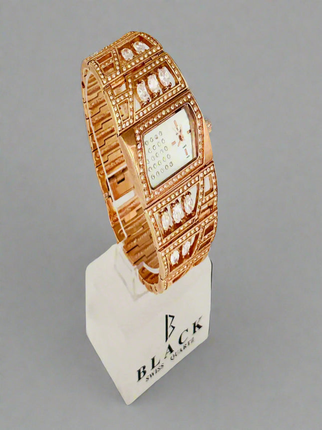 Rose gold watch on a display stand with 'Black' branding