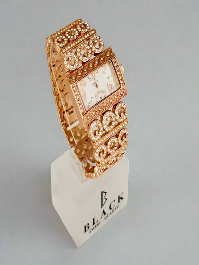 Rose gold watch on a white stand with a light gray background