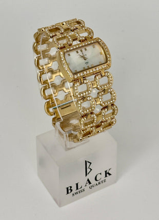 Gold bracelet watch on a white stand with 'Black Swiss Quartz' branding.