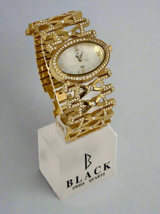 Gold wristwatch with decorative design on a white stand featuring 'BLACK SWISS QUARTZ' branding.