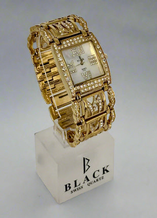 Gold wristwatch on a white stand with 'Black Swiss Quartz' branding