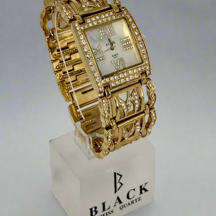 Gold wristwatch on a white stand with 'Black Swiss Quartz' branding