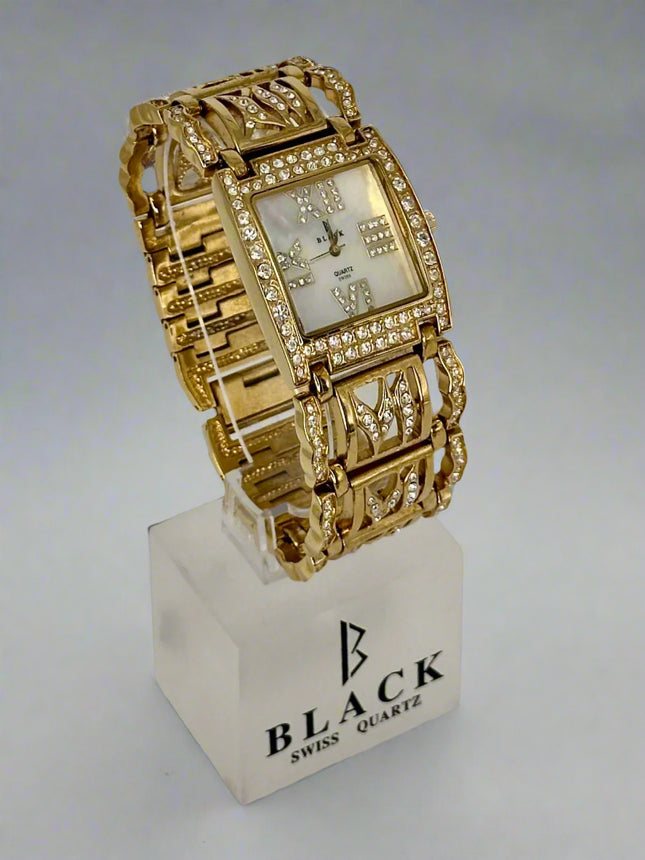Gold wristwatch on a white stand with 'Black Swiss Quartz' branding