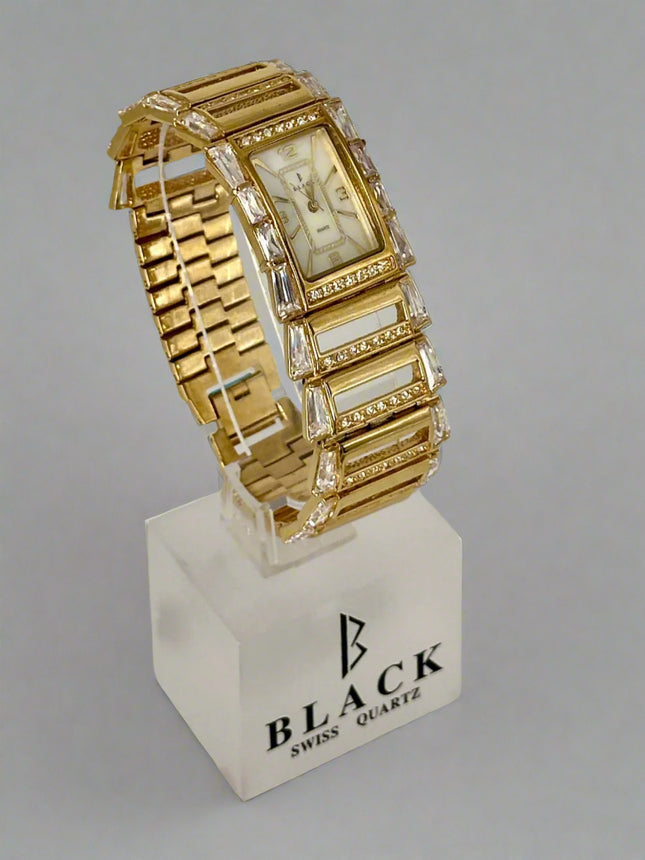 Gold wristwatch with intricate design on a gray background
