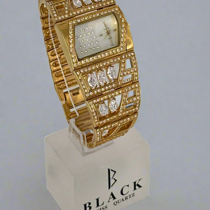 Gold wristwatch with diamond accents on a stand featuring 'Black Swiss Quartz' branding.