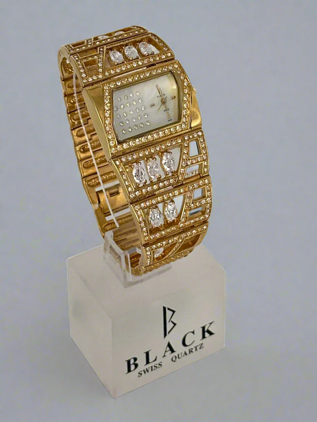 Gold wristwatch with diamond accents on a stand featuring 'Black Swiss Quartz' branding.