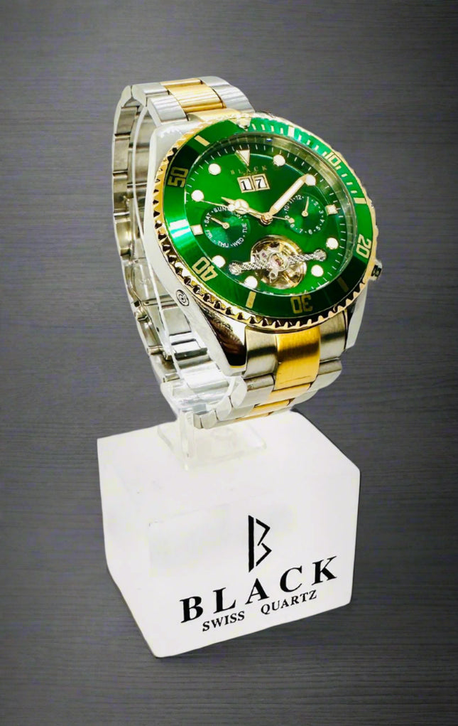 Green and silver watch on a white stand with 'Black Swiss Quartz' branding.