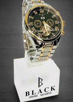 Two-tone watch with black face and gold accents on a white stand with 'BLACK' branding.