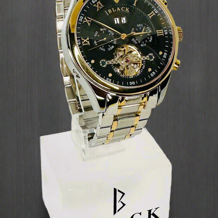 Luxury watch with black face and gold accents on a white background