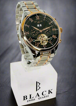 Two-tone watch on a stand with 'Black Swiss Quartz' branding