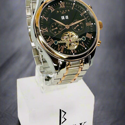 Two-tone watch on a stand with 'Black Swiss Quartz' branding