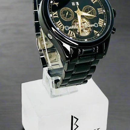 Black Swiss Quartz watch on a white stand with a white background