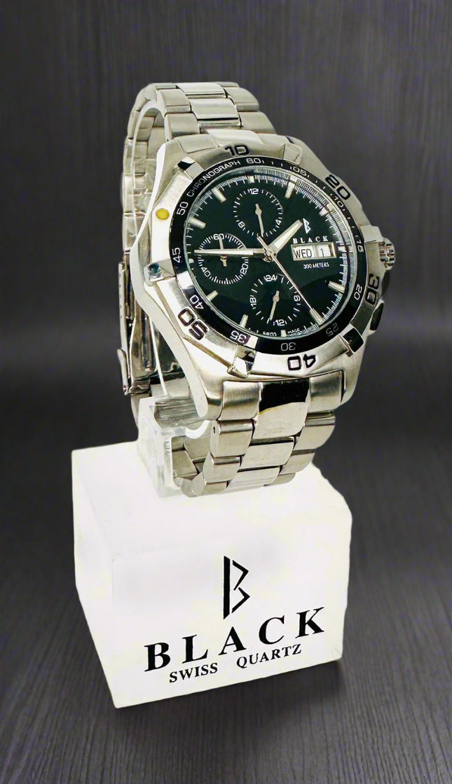 Silver wristwatch with black face on a white background, featuring the brand 'Black Swiss Quartz'.