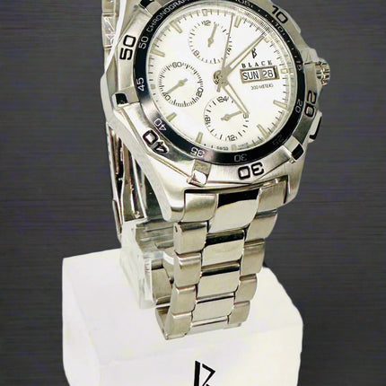 Silver watch on a white stand with 'Black Swiss Quartz' branding
