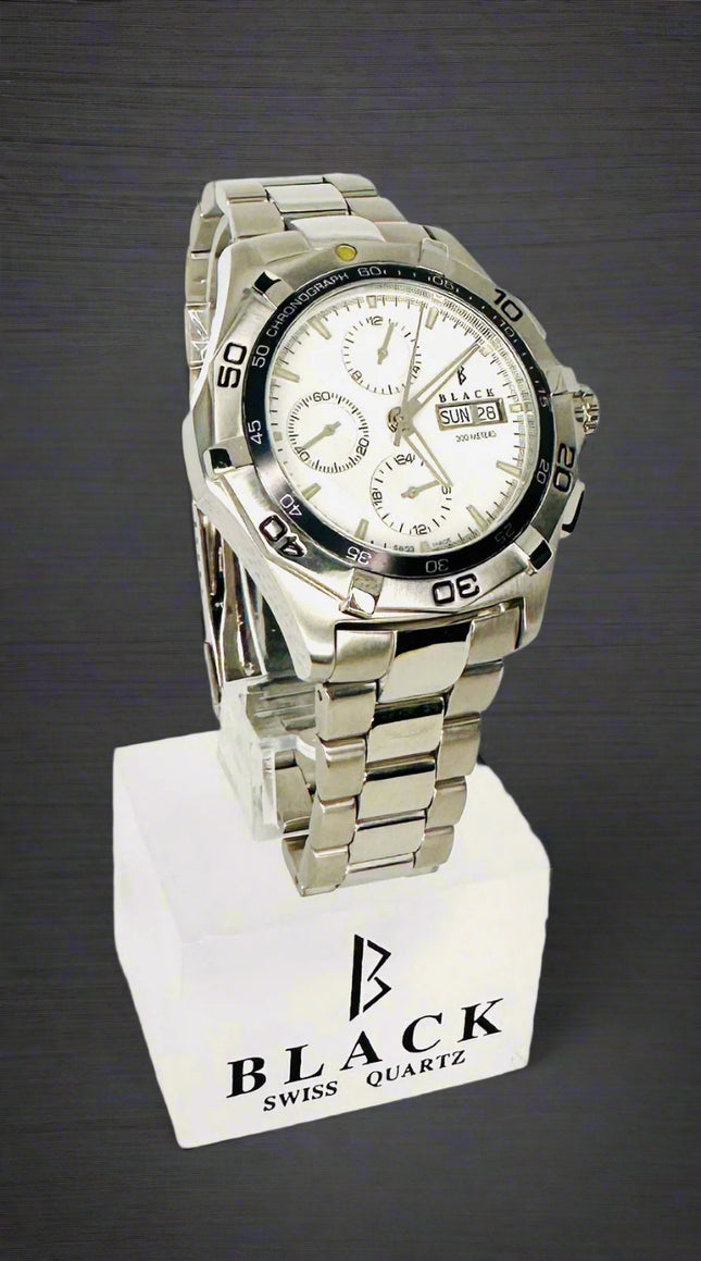 Silver watch on a white stand with 'Black Swiss Quartz' branding