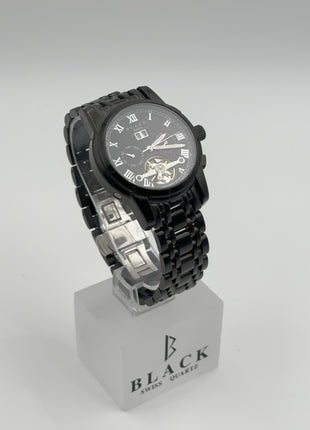 Black wristwatch on a white stand with 'BLACK' branding