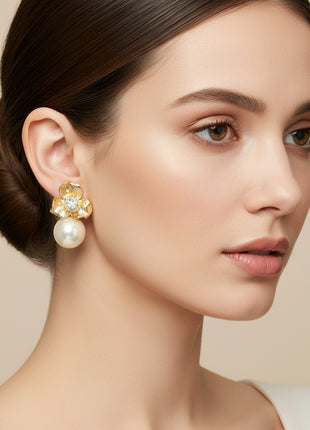Close-up of a woman wearing a pearl earring with a beige background