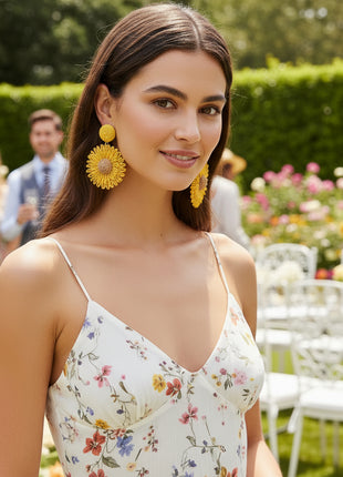 Yellow floral earrings on a black background