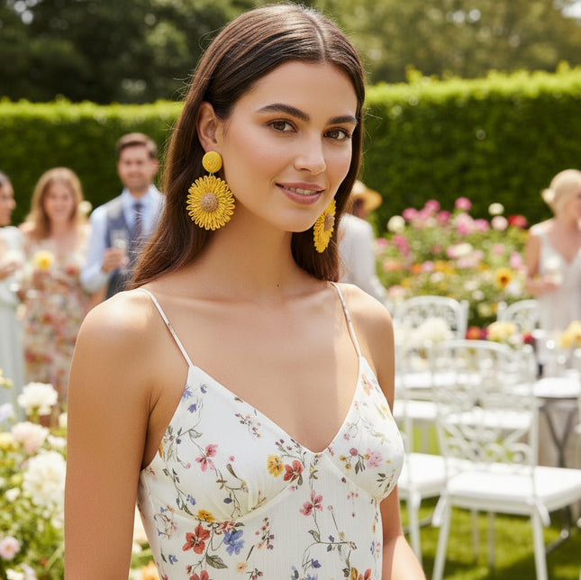 Yellow floral earrings on a black background