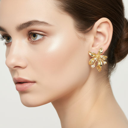 Close-up of a woman wearing a gold earring on a light background