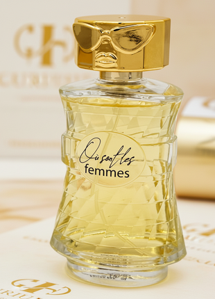 Perfume bottle labeled 'Ousafles femmes' with gold cap on a white background
