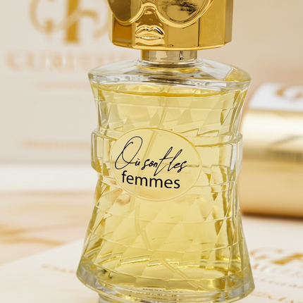 Perfume bottle labeled 'Ousafles femmes' with gold cap on a white background