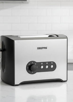 Silver toaster with black control panel on a white background